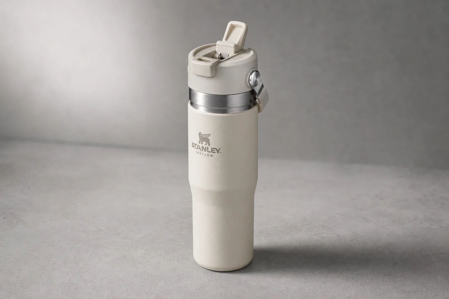 Six insulated water bottles from different brands arranged on concrete surface
