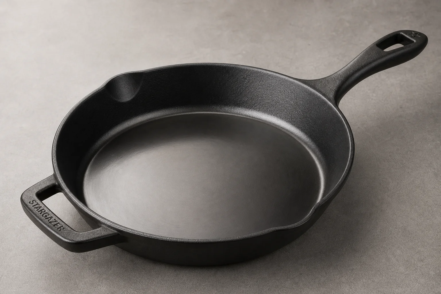 Five cast iron skillets arranged on wooden surface showing variety of styles and finishes