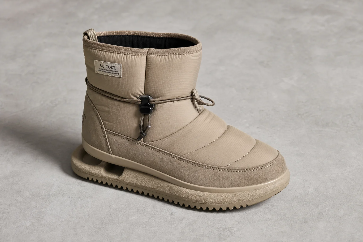 Collection of diverse winter boots arranged on concrete surface