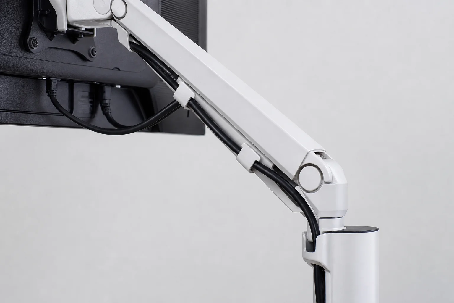 Monitor arm with cable management clips routing power and display cables neatly