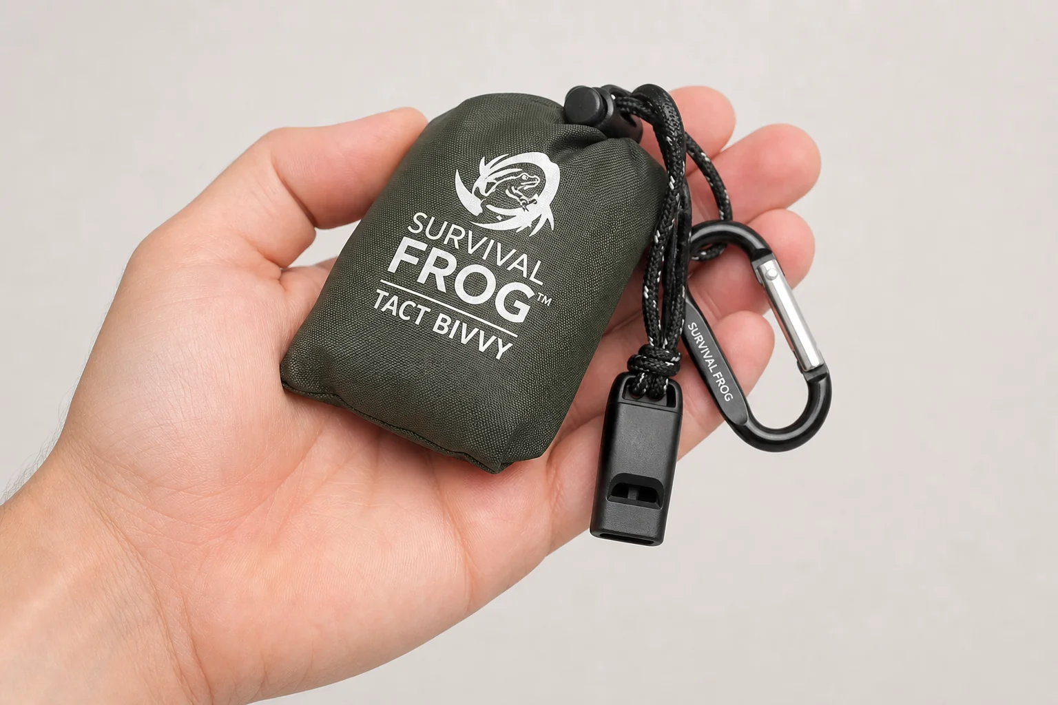 Five survival bivvy sacks in various colors arranged on concrete surface