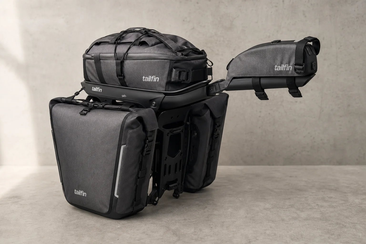 Complete Tailfin cargo system with AeroPack, panniers, and top tube bag on concrete