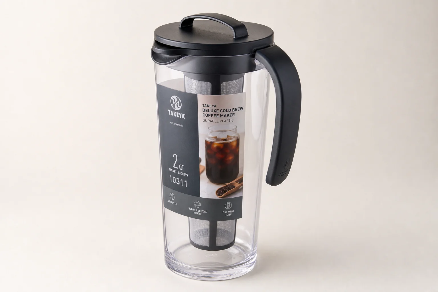 Four cold brew coffee makers displayed on concrete surface