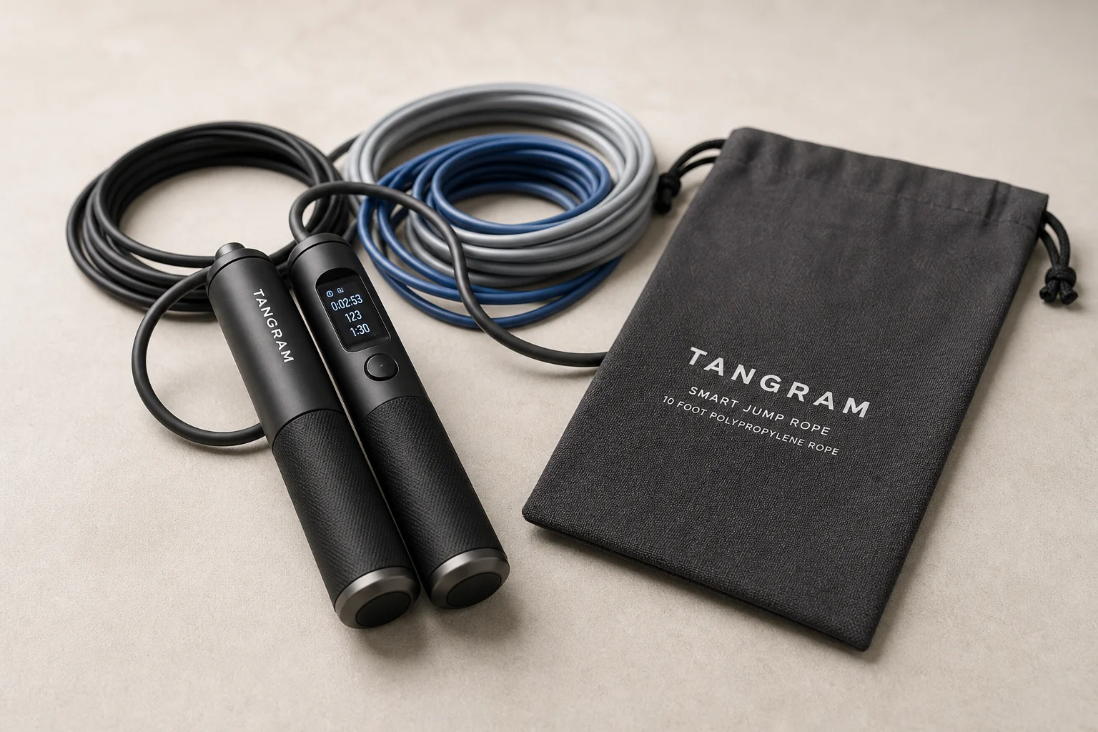 Five smart jump ropes with different handle colors and designs arranged on concrete