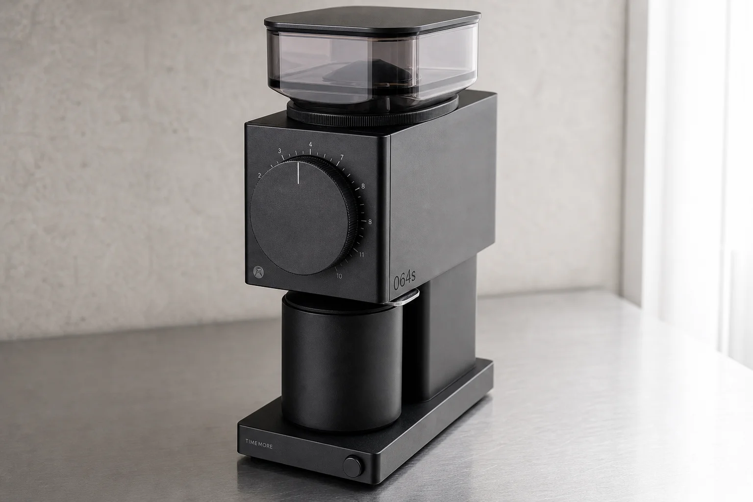 Seven espresso grinders of various sizes and styles arranged on concrete surface