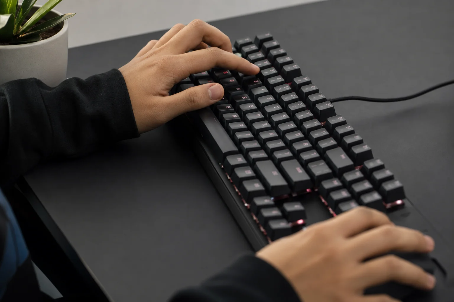 Gamer's hands on keyboard during active gaming session