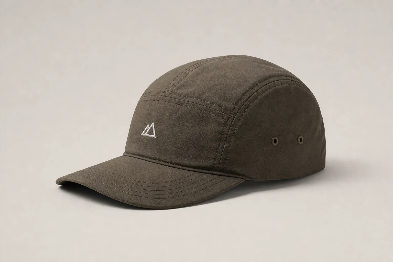 Nine running caps in various styles and colors arranged on neutral backdrop
