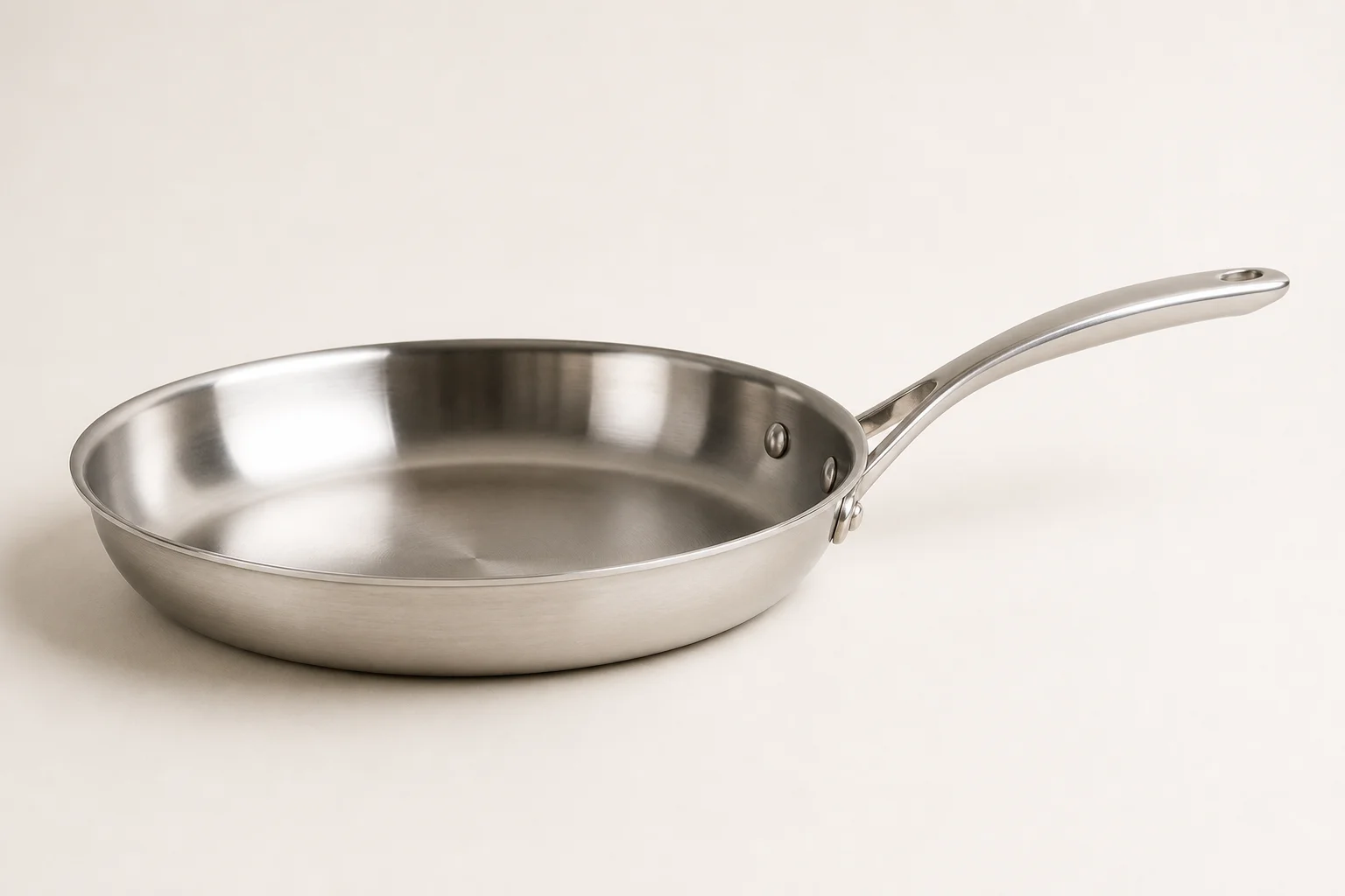 Collection of budget cookware including stainless steel, cast iron, non-stick, and enameled pans