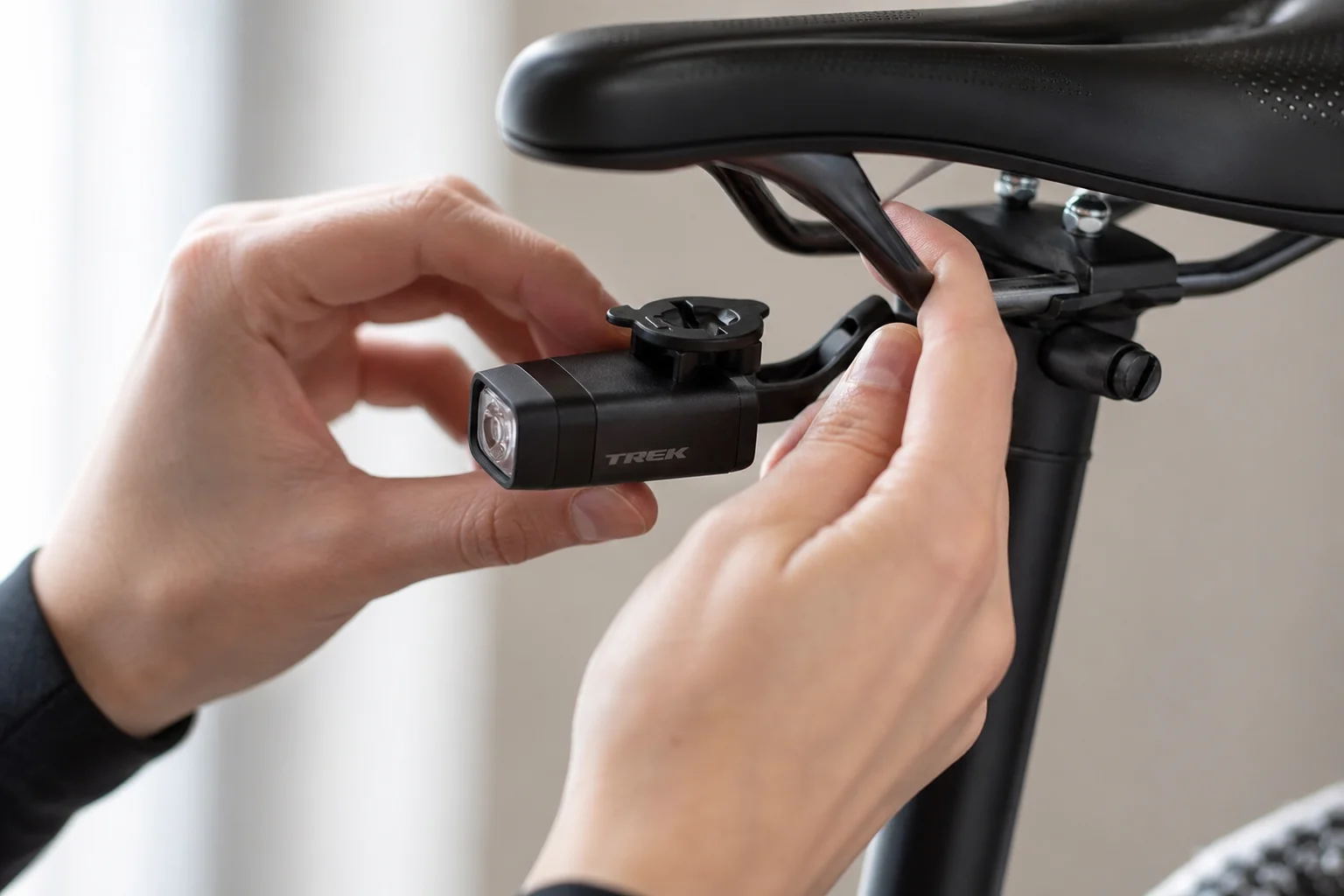 Cyclist mounting compact light on bike using blender-style attachment