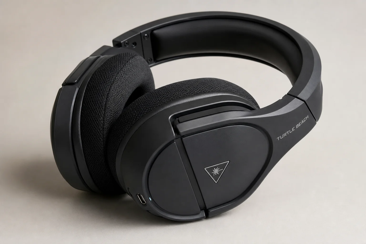 Four gaming headsets displayed in a row on concrete surface