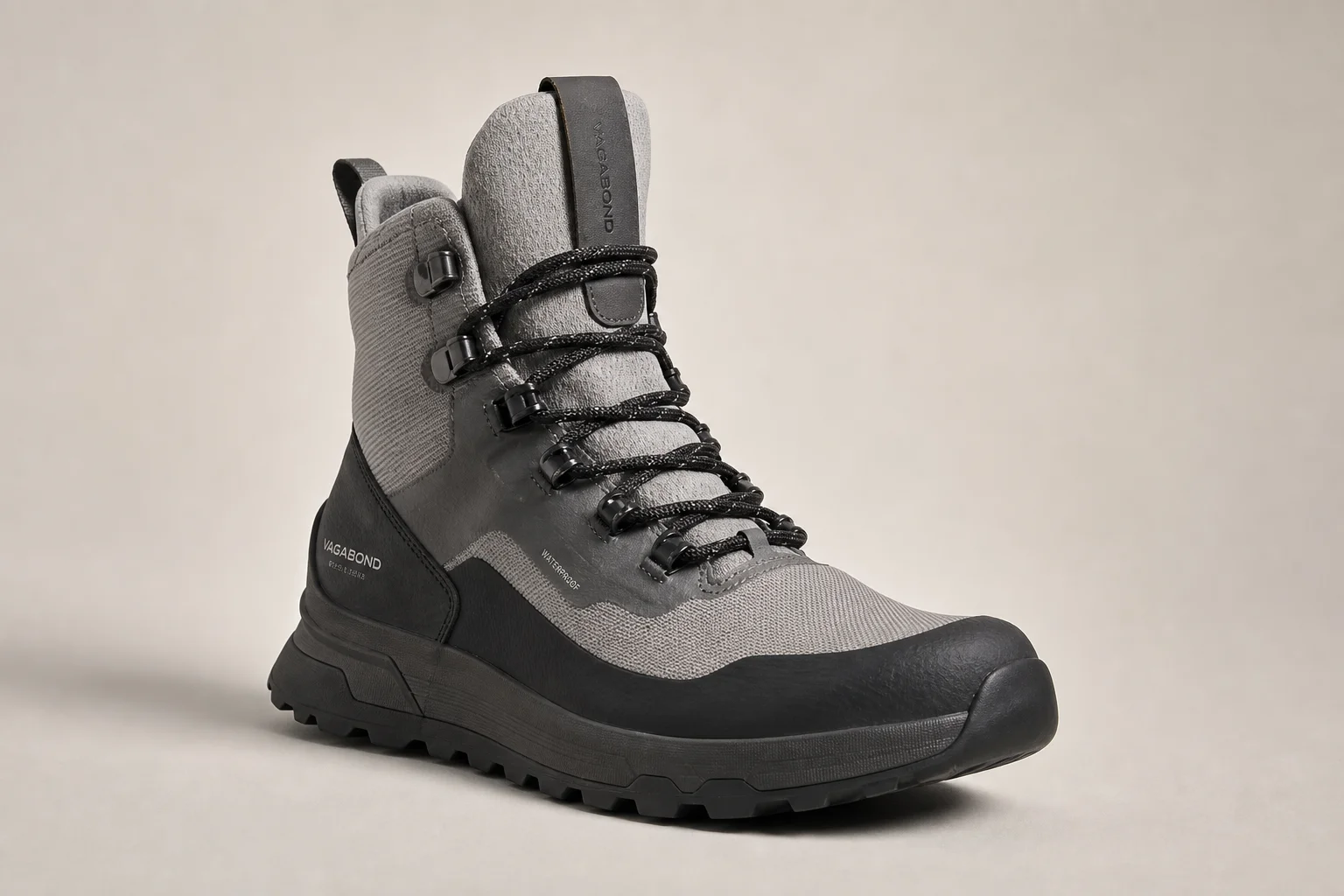 Collection of diverse winter boots arranged on concrete surface
