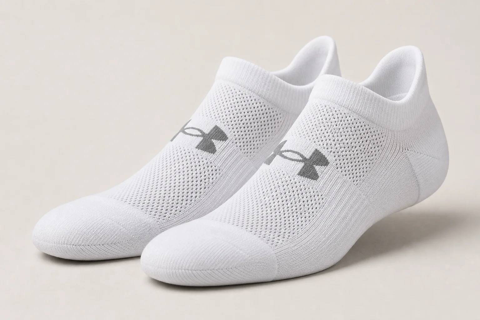 Collection of various running socks in different colors and styles on neutral backdrop