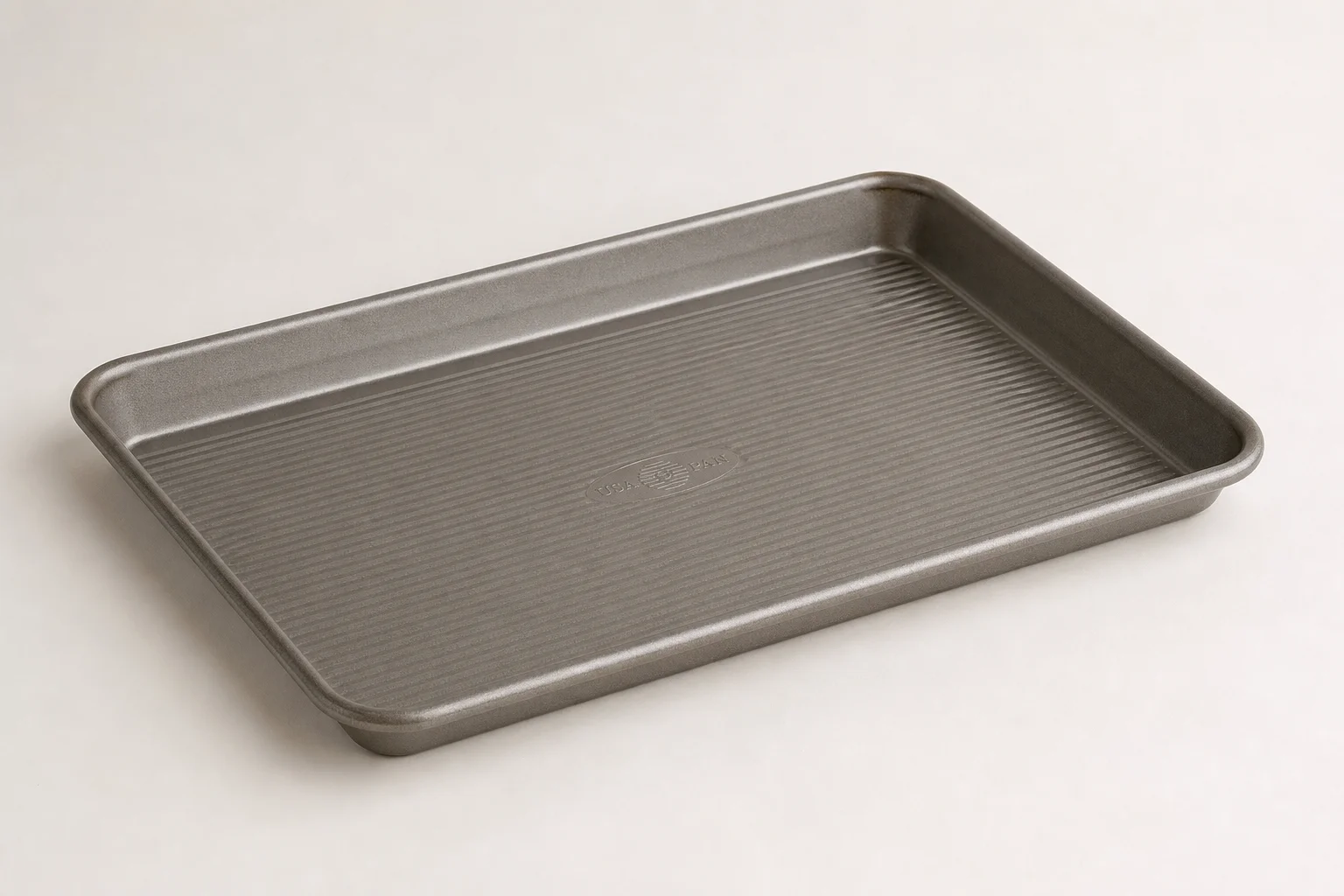 Six sheet pans arranged in a grid showing different styles and materials