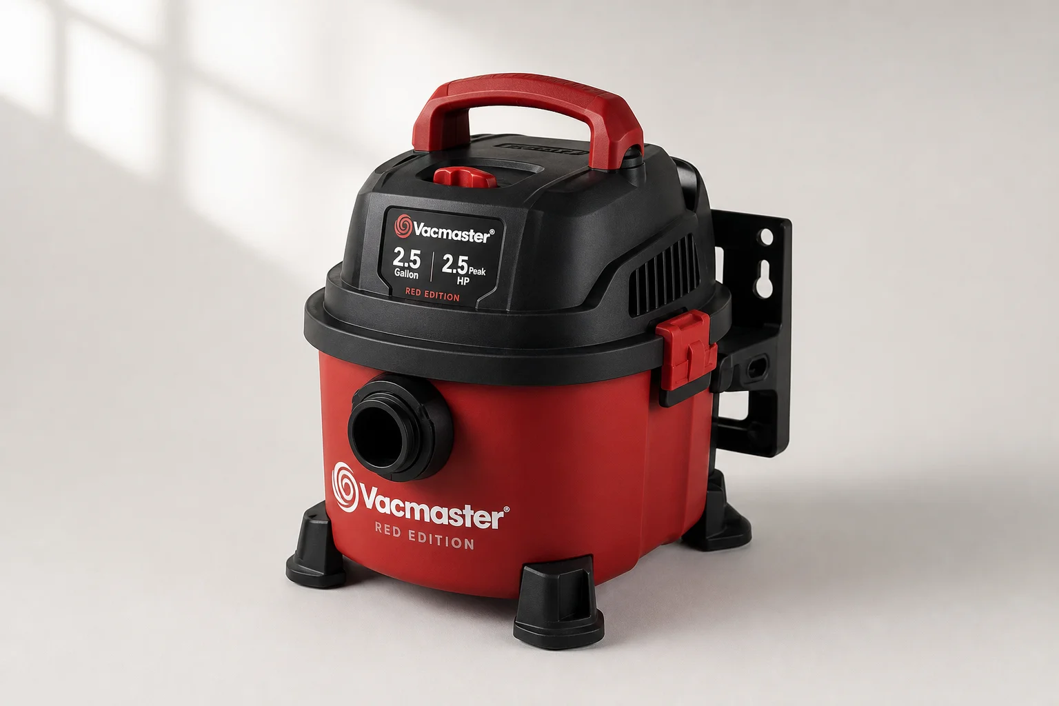 Five shop vacuums of varying sizes arranged on a concrete workshop floor