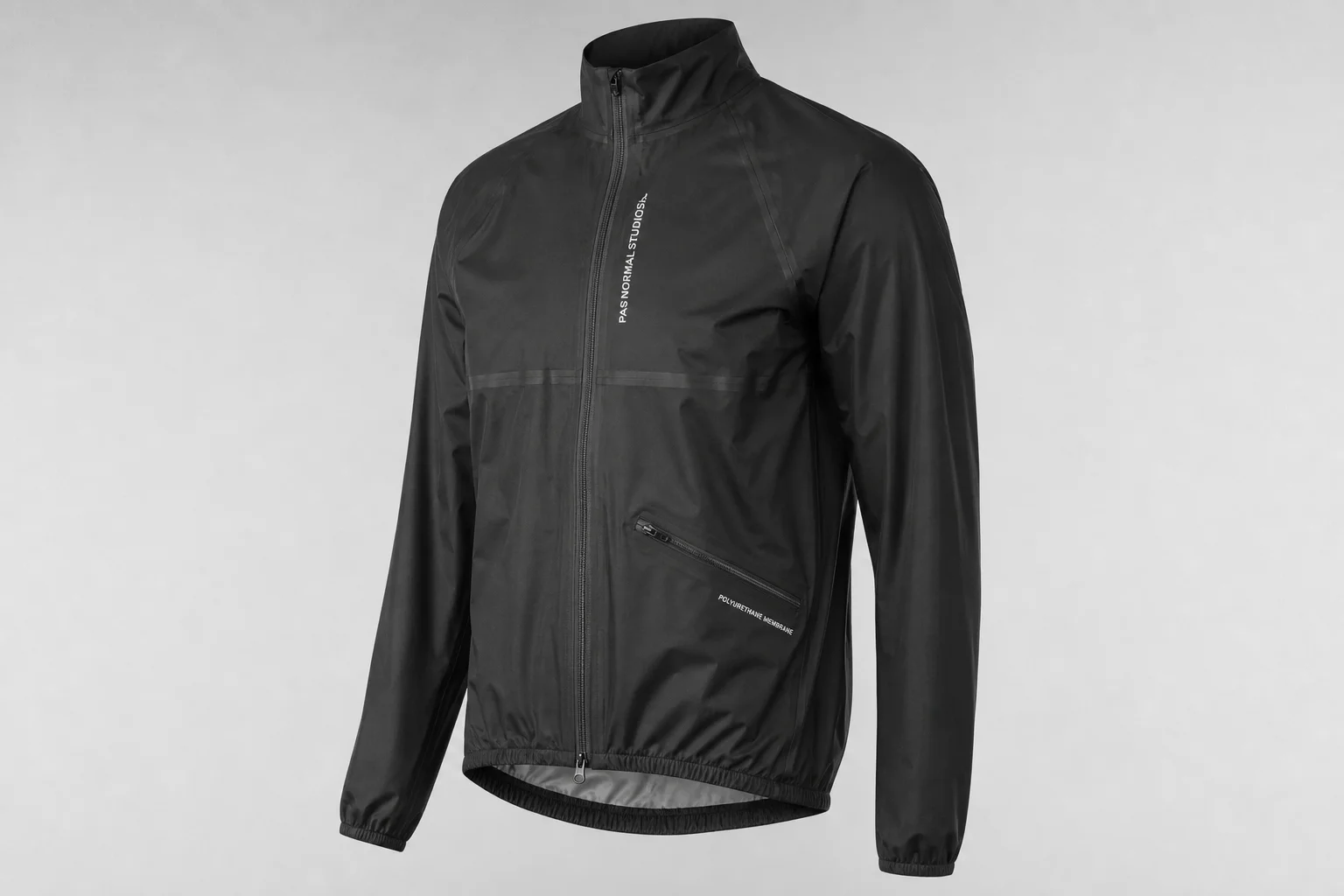 Five cycling rain jackets in various colors arranged on neutral backdrop