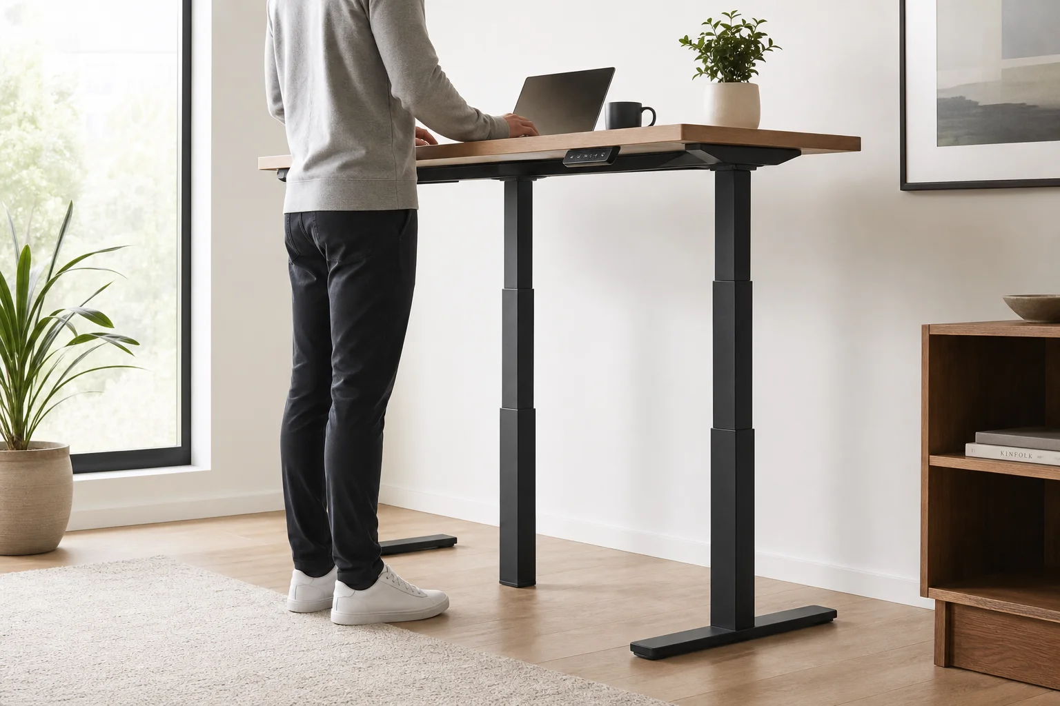 Standing desk at maximum height with a person working in an upright position