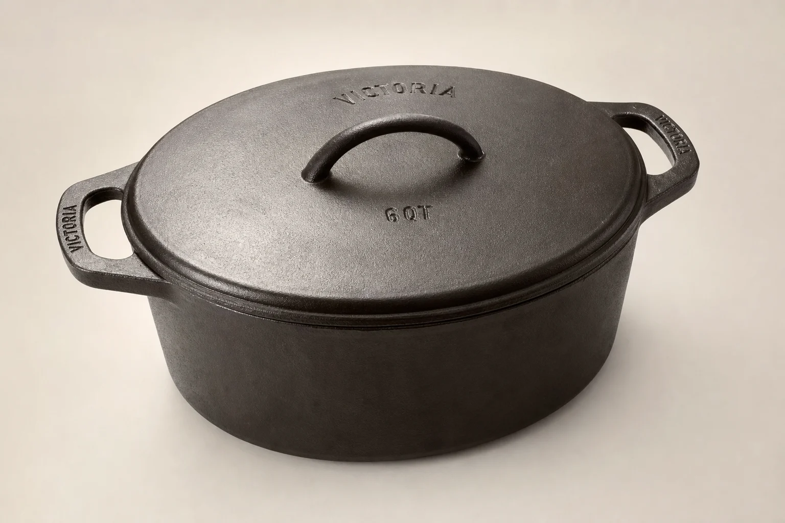 Six Dutch ovens in different sizes arranged on concrete surface
