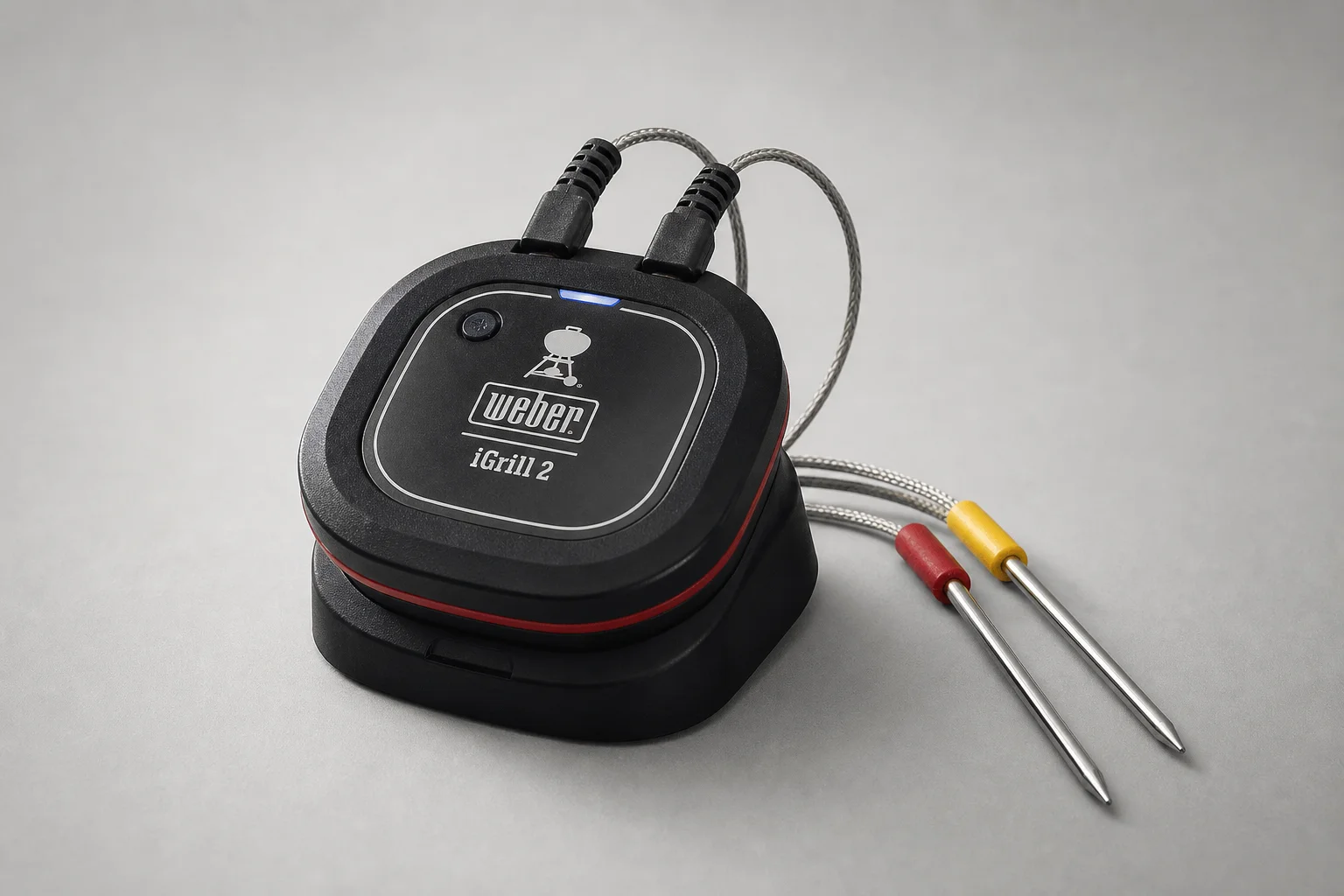 Three smart meat thermometer systems displayed on concrete surface