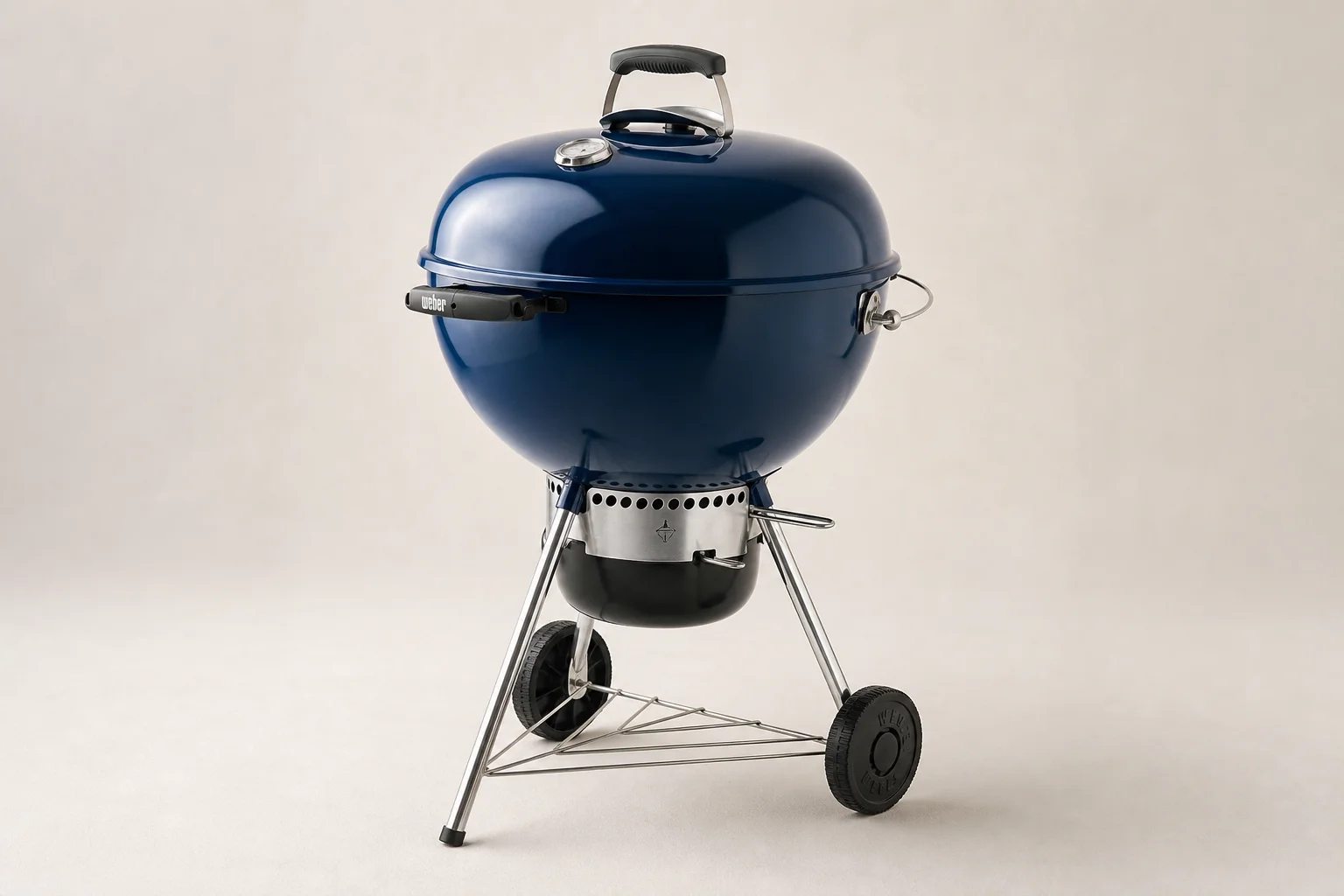 Three Weber 22-inch kettle grills lined up showing Original, Premium, and Master Touch models