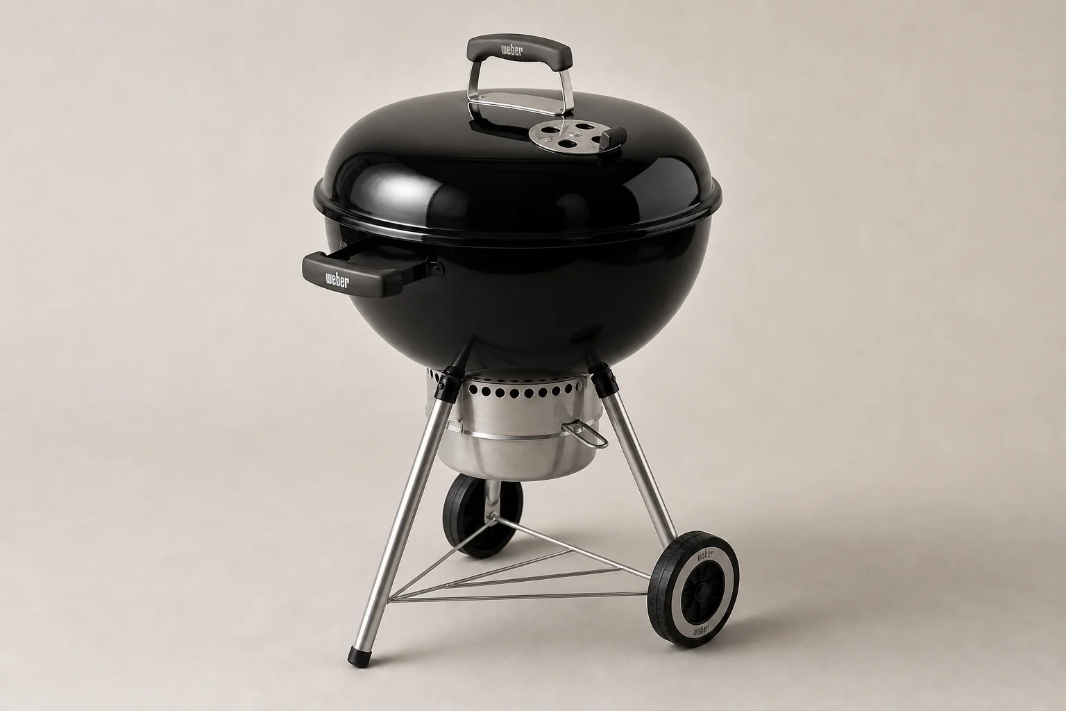 Three Weber 22-inch kettle grills lined up showing Original, Premium, and Master Touch models