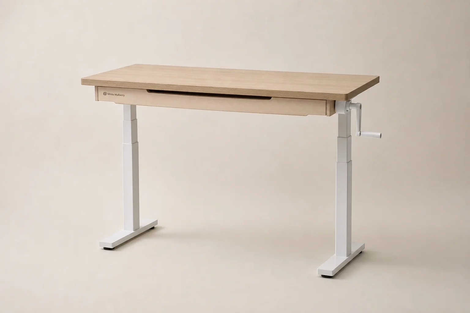 Modern standing desk in raised position with laptop and monitor in bright home office