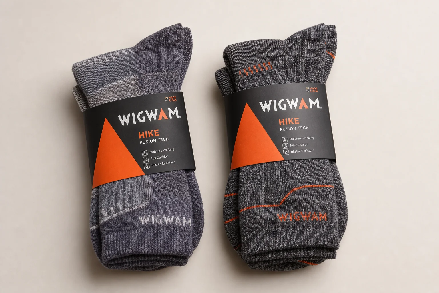 Collection of hiking socks in various styles and materials on neutral backdrop