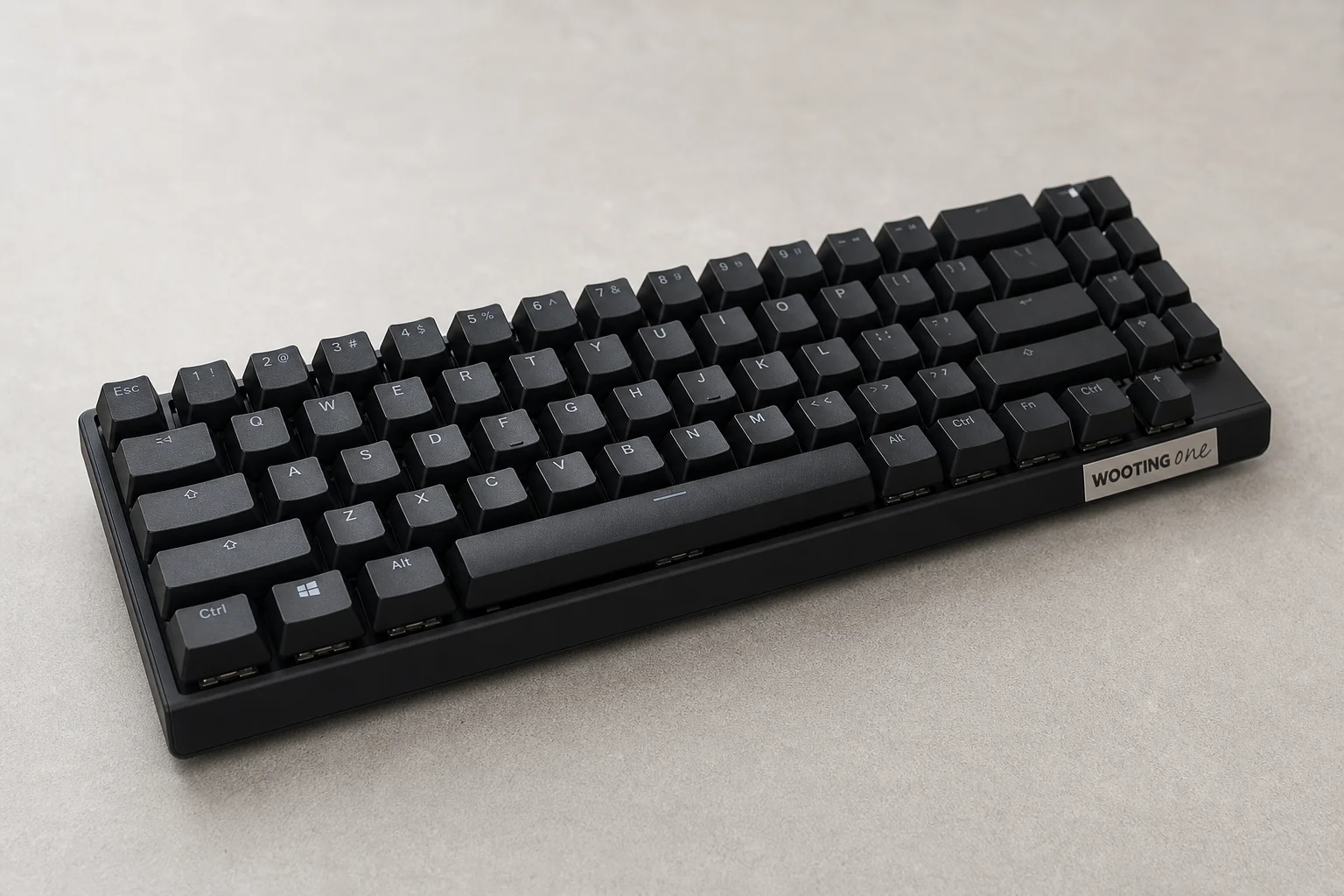 Modern compact gaming keyboard with matte black finish on brushed aluminium surface