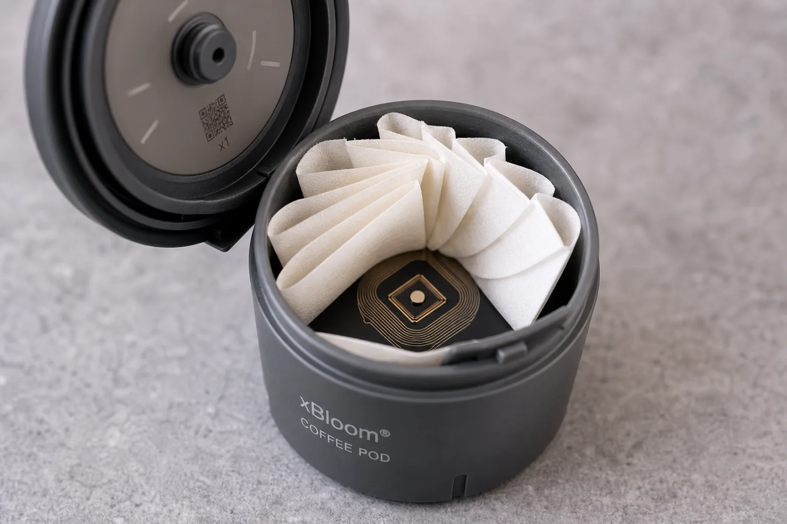 Close-up of xBloom pod showing folded filter paper and RFID chip