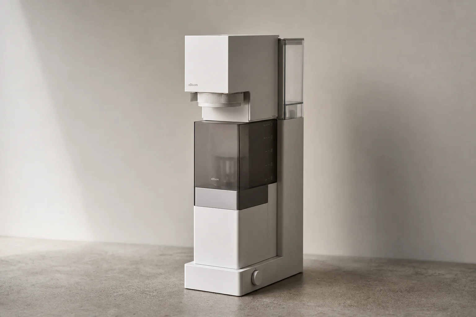 xBloom coffee brewer standing on concrete surface showing tall narrow design