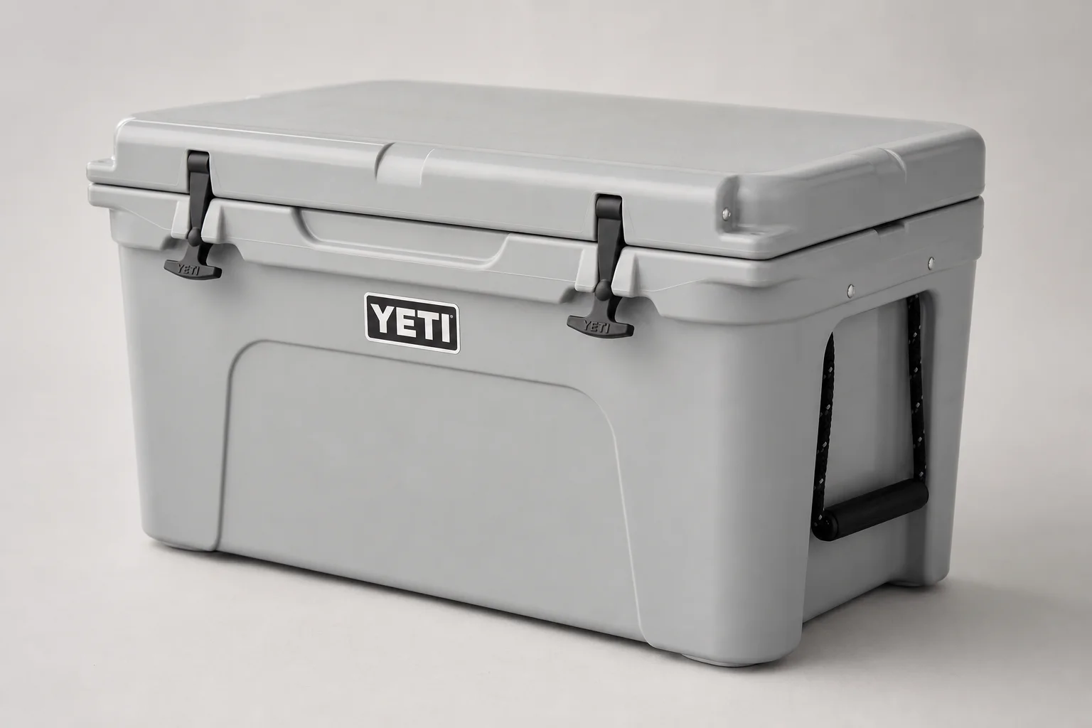 Camping kitchen setup with portable table, cooler, and cooking equipment