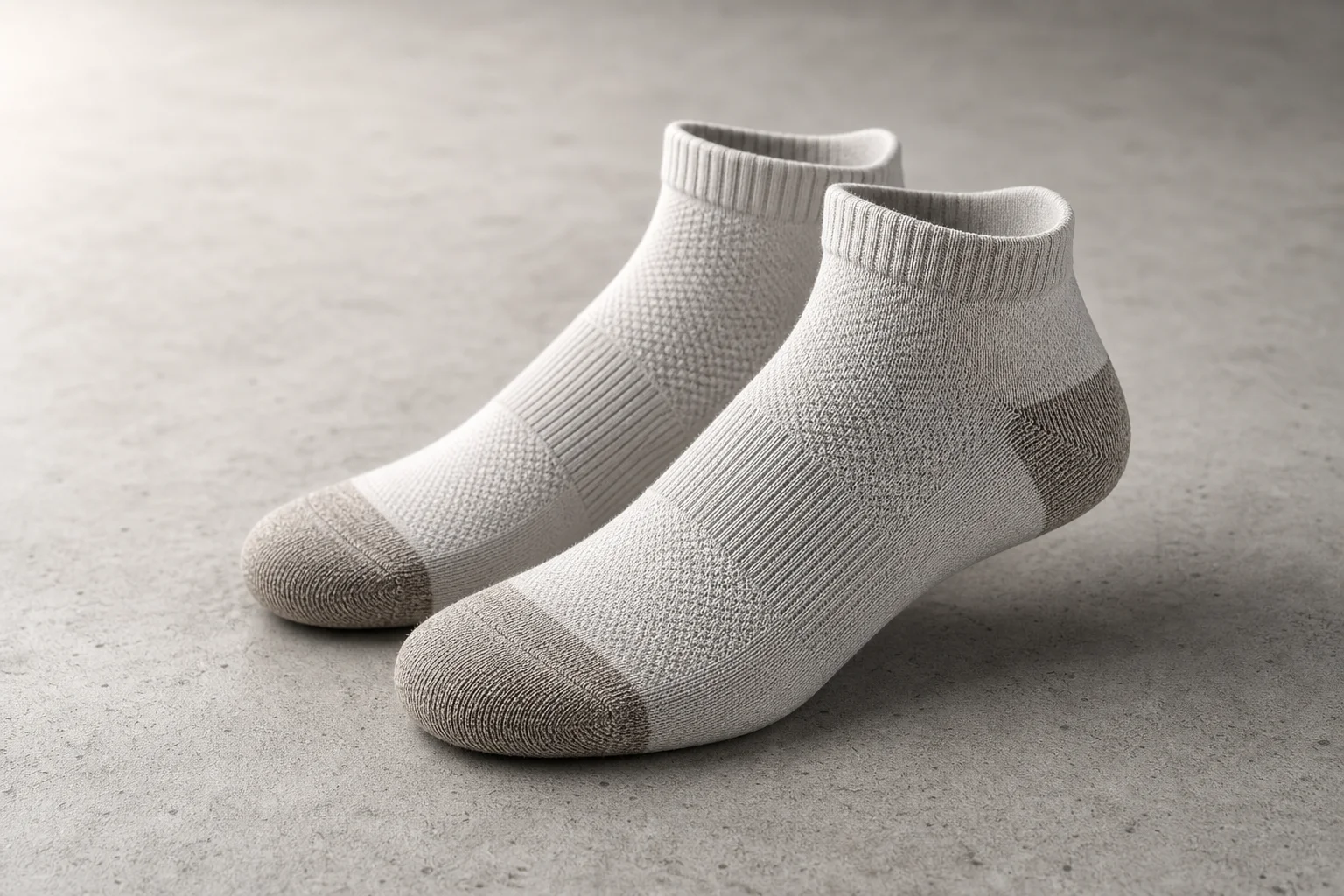 Collection of various running socks in different colors and styles on neutral backdrop
